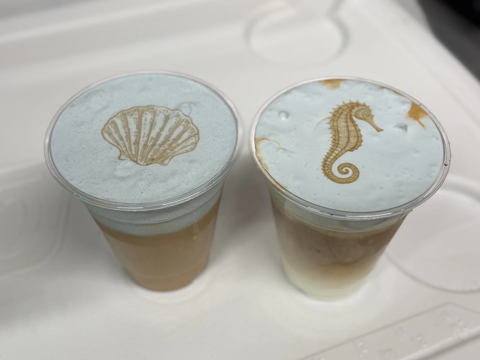 Branded cups topped with fresh latte art