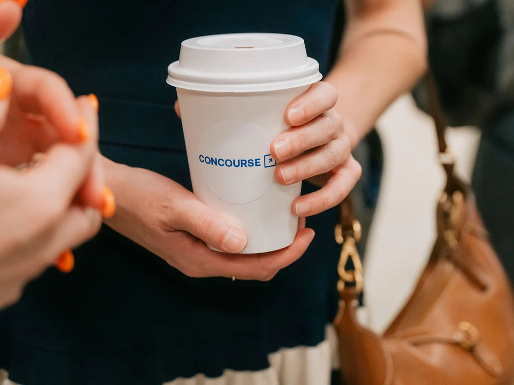 Guest holding a custom branded Zerno coffee cup