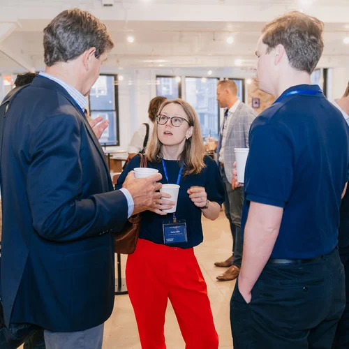 Conference attendees chatting during a coffee break