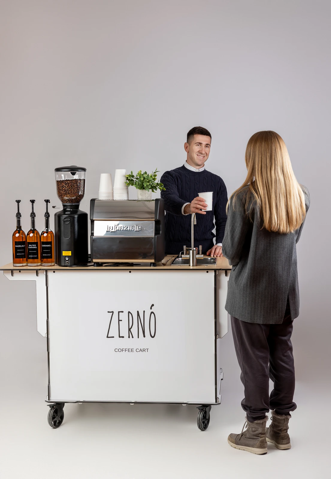 Guest chatting with the Zerno barista at the coffee cart