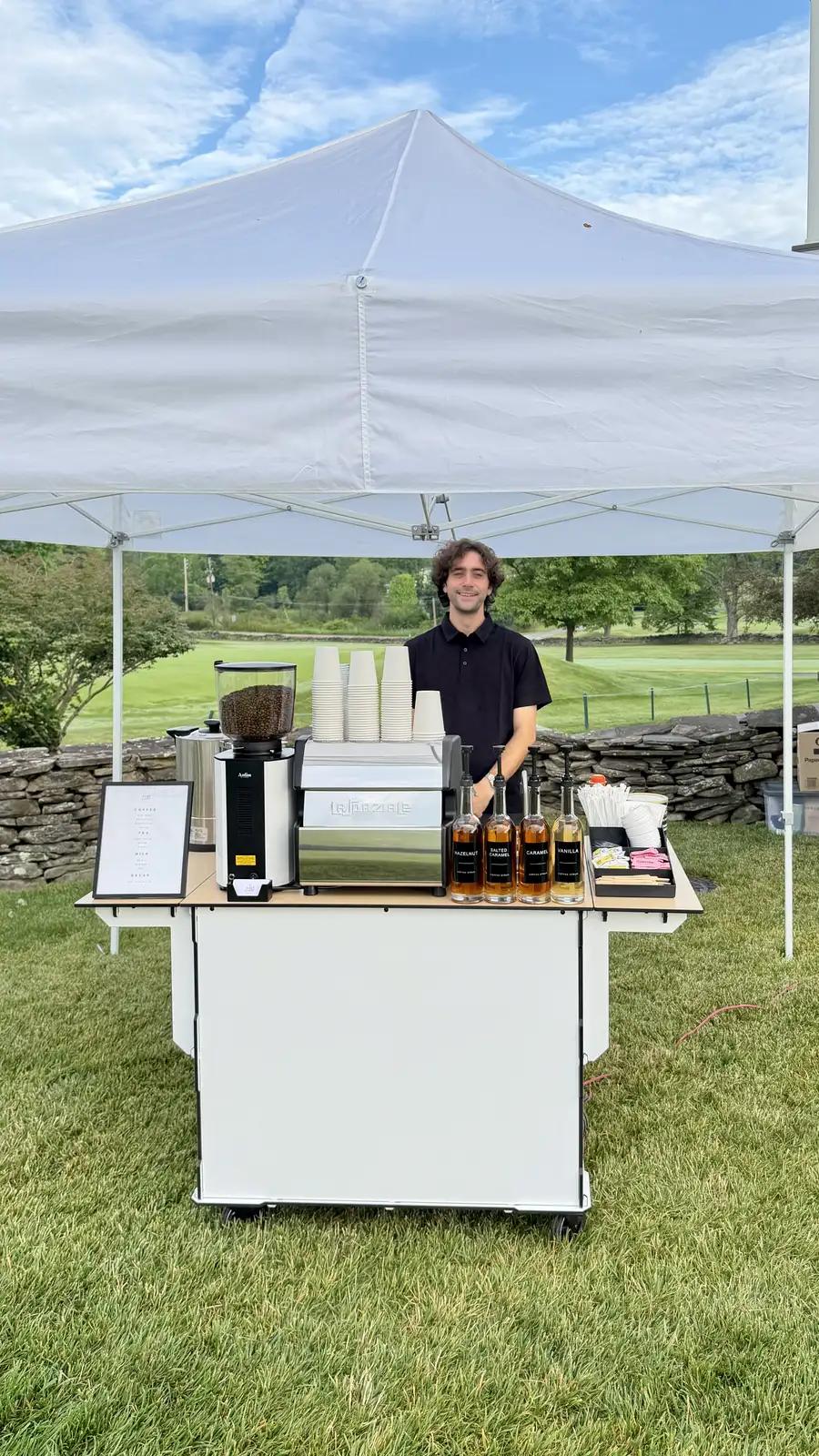 Zerno barista serving under a tent at an outdoor event