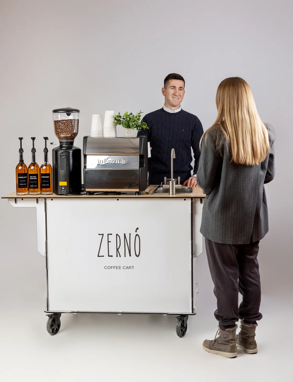 Zerno barista serving a guest at the mobile espresso cart