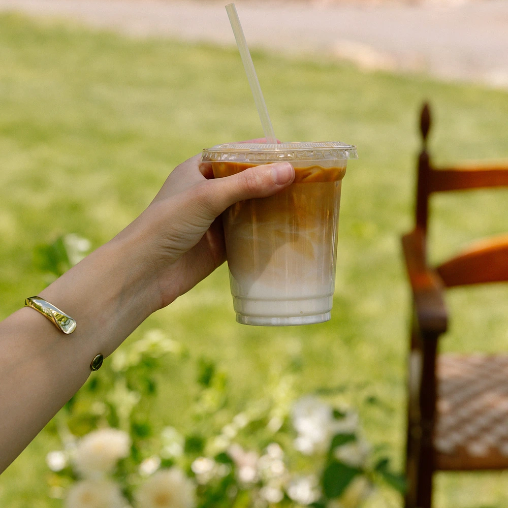 Guest holding an iced latte at an outdoor private event