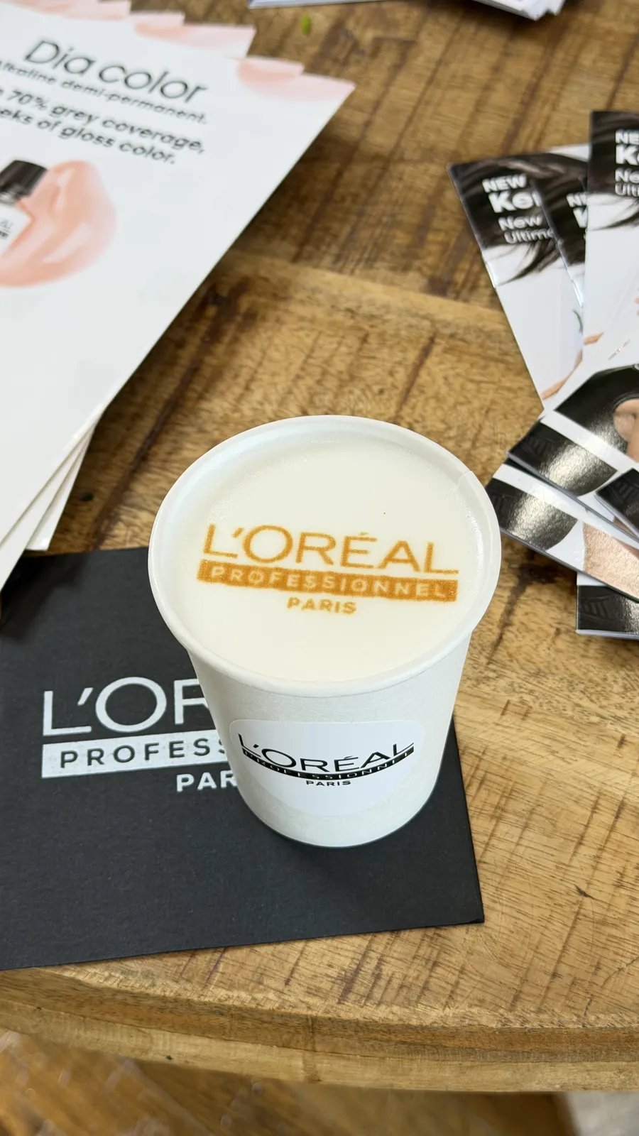 Custom logo latte art poured in a branded cup at a corporate event